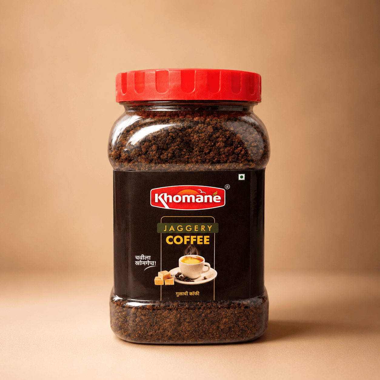 Khomaane Jaggery Coffee jar with a red lid, showing coffee granules and a cup of coffee.